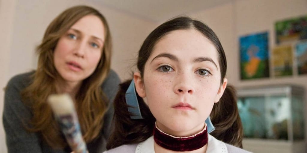 A concerned adult looking at a young girl wearing a neck brace.