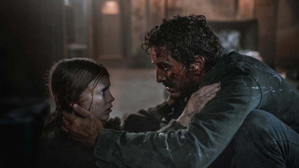 A man with a bloodied face and a woman sharing an intense moment with physical contact.