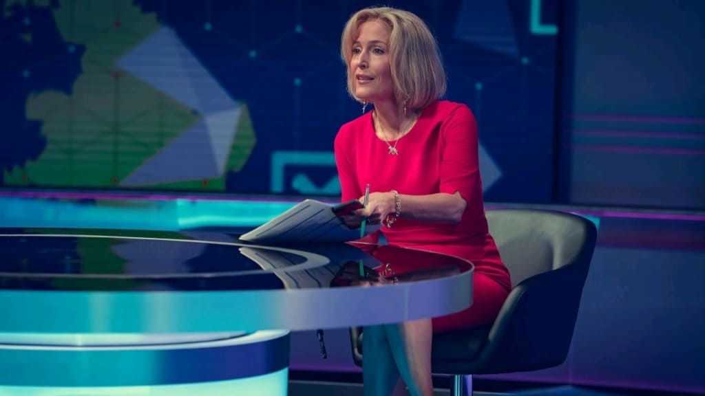 Tv news anchor preparing for a broadcast at the news desk.