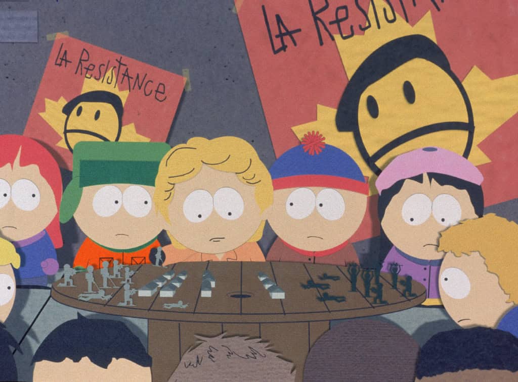 Children from the animated show "south park" looking at a chessboard, with protest signs reading "la résistance" in the background.