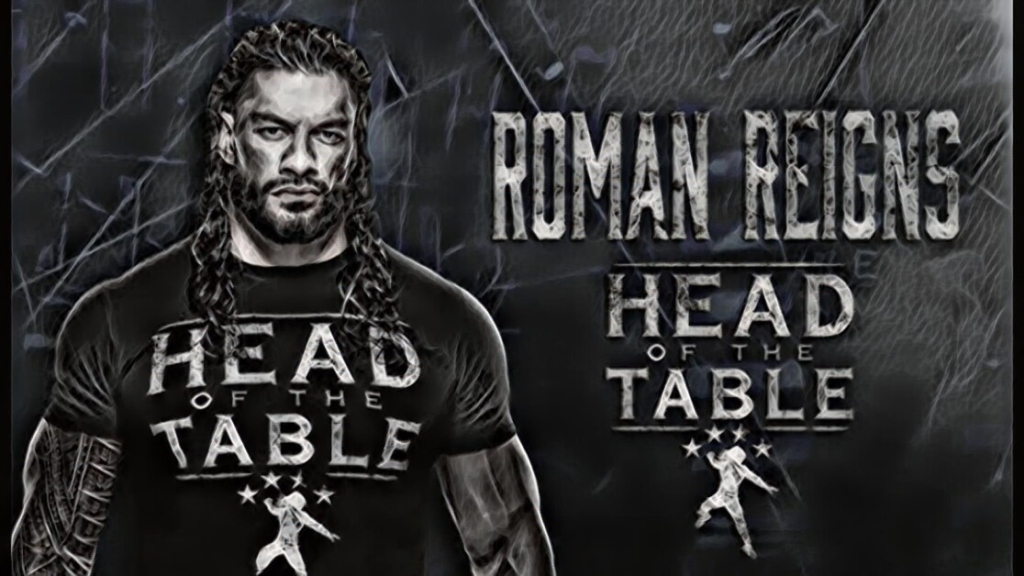 A stylized monochrome image of wrestler Roman Reigns wearing a "Head of the Table" T-shirt, with his name and title graphically displayed behind him.