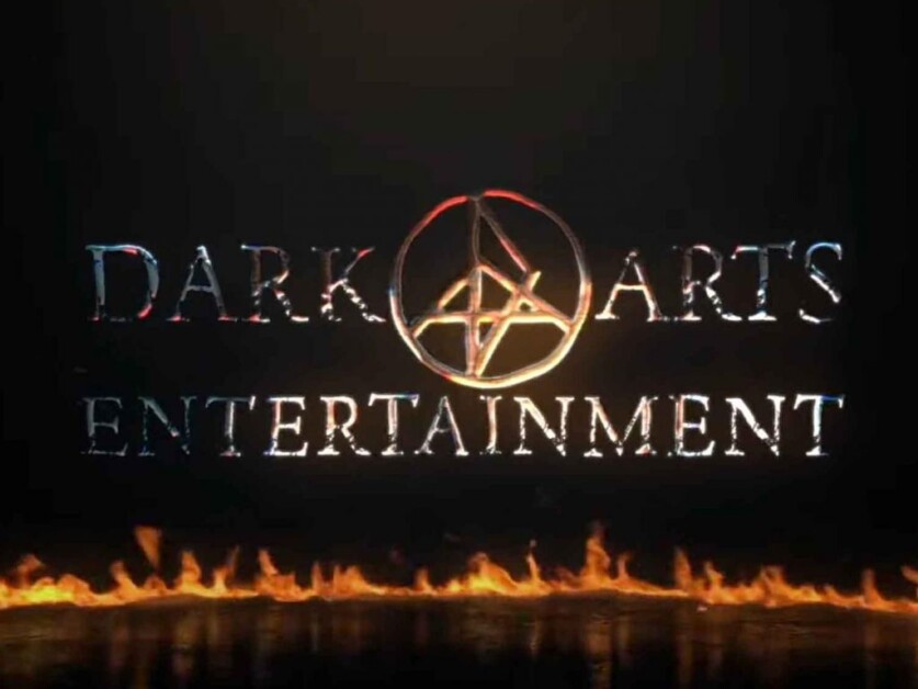 Dark Arts Entertainment" logo with a fiery pentagram symbol in the center and flames at the bottom.