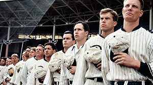 ‘Eight Men Out’ Blu-Ray Review – All-Star Cast Explores The Dark Days Of Baseball A group of male baseball players in vintage uniforms looking intently to their left in a stadium.
