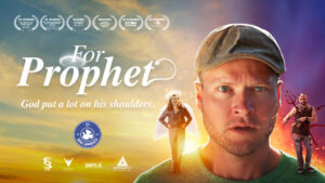 Movie poster for "For Prophet" featuring a man in a baseball cap looking surprised. The tagline reads, "God put a lot on his shoulders." Two smaller characters, an angel and a demon, are on his shoulders.