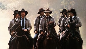 ‘The Long Riders’ (Special Edition) Blu-Ray Review – A Star-Studded Telling Of The Jesse James Story A group of seven men wearing traditional hats and coats riding horses in a misty, wooded area.