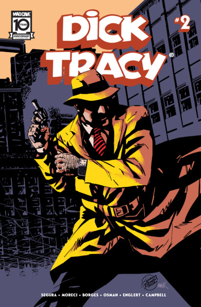 Comic book cover featuring Dick Tracy in a yellow trench coat and fedora, holding a gun, with an urban backdrop. Text at the top reads, "Dick Tracy #2".