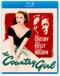 Blu-ray cover of the movie "The Country Girl" featuring a woman in a formal dress in the foreground and two men’s profiles in the background, with cast names Bing Crosby, Grace Kelly, and William Holden.
