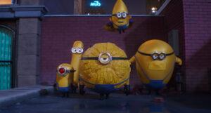 Universal To Release The Hit Animated Sequel ‘Despicable Me 4’ On 4K UHD Blu-Ray With Exclusive Extras Five yellow, cylindrical characters with goggles stand and float in an urban alleyway with brick walls and buildings visible in the background.