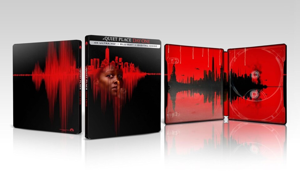 Image shows a "A Quiet Place: Day One" limited edition 4K Ultra HD Blu-ray steelbook. The case features a red and black soundwave design, and an image of an urban skyline inside the cover.