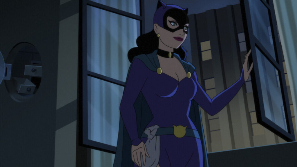 A woman in a purple superhero costume with a mask and cat ears stands by an open window, looking outside at night.