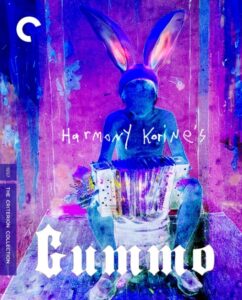 Colorful cover of the movie "Gummo" from The Criterion Collection, featuring a character with bunny ears and an accordion, set against an abstract background. Text includes "Harmony Korine" and the Criterion logo.