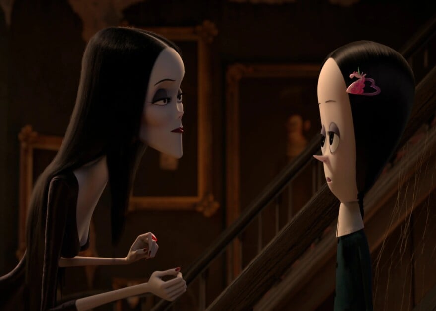 A tall woman with long dark hair talks to a girl with black hair and a pink hair clip on a staircase. Paintings are visible in the background.