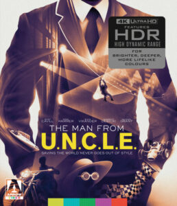 Cover of "The Man from U.N.C.L.E" 4K Ultra HD edition, showcasing a suited man against a backdrop of action scenes with text highlighting "HDR" features and tagline "Saving the World Never Goes Out of Style".