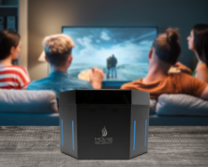 Two people watching a movie on a TV while sitting on a couch. In the foreground, a device labeled "Movie Scent" is placed on a table.
