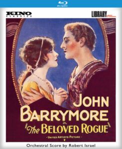 Vintage movie poster for "The Beloved Rogue" featuring a man and woman gazing at each other against an ornate backdrop.