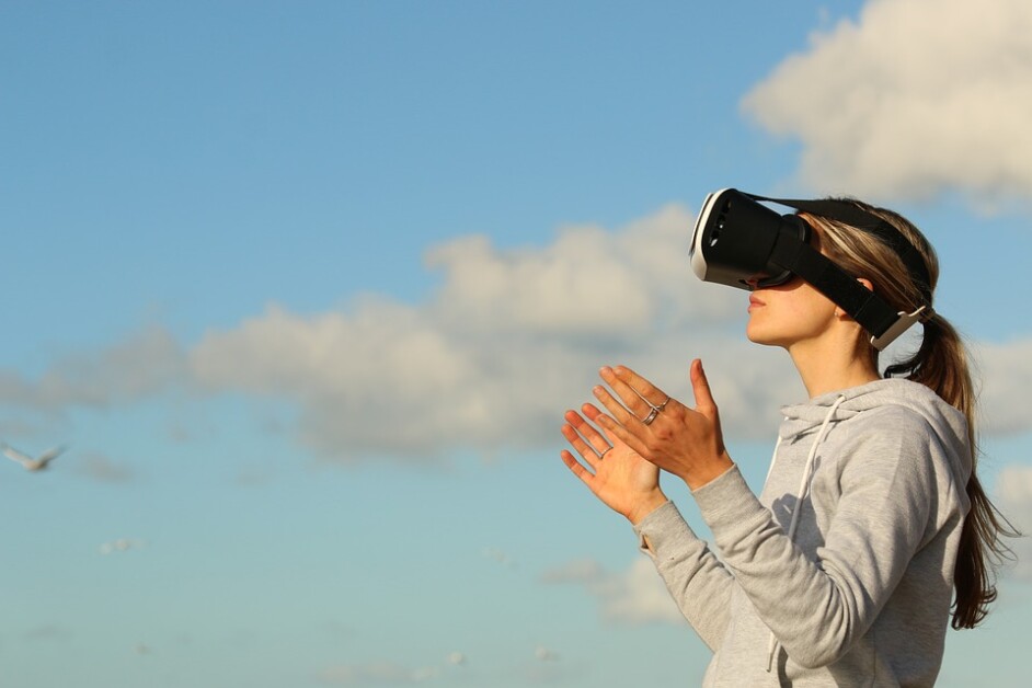 A woman wearing a VR Headset standing outside