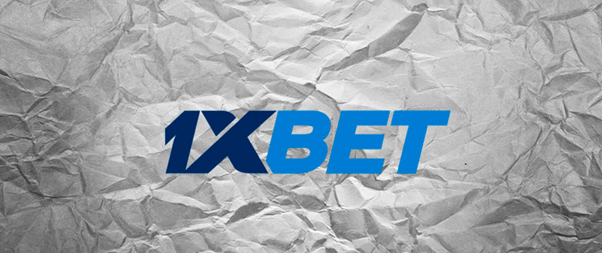 1XBET logo on a crumpled paper background.