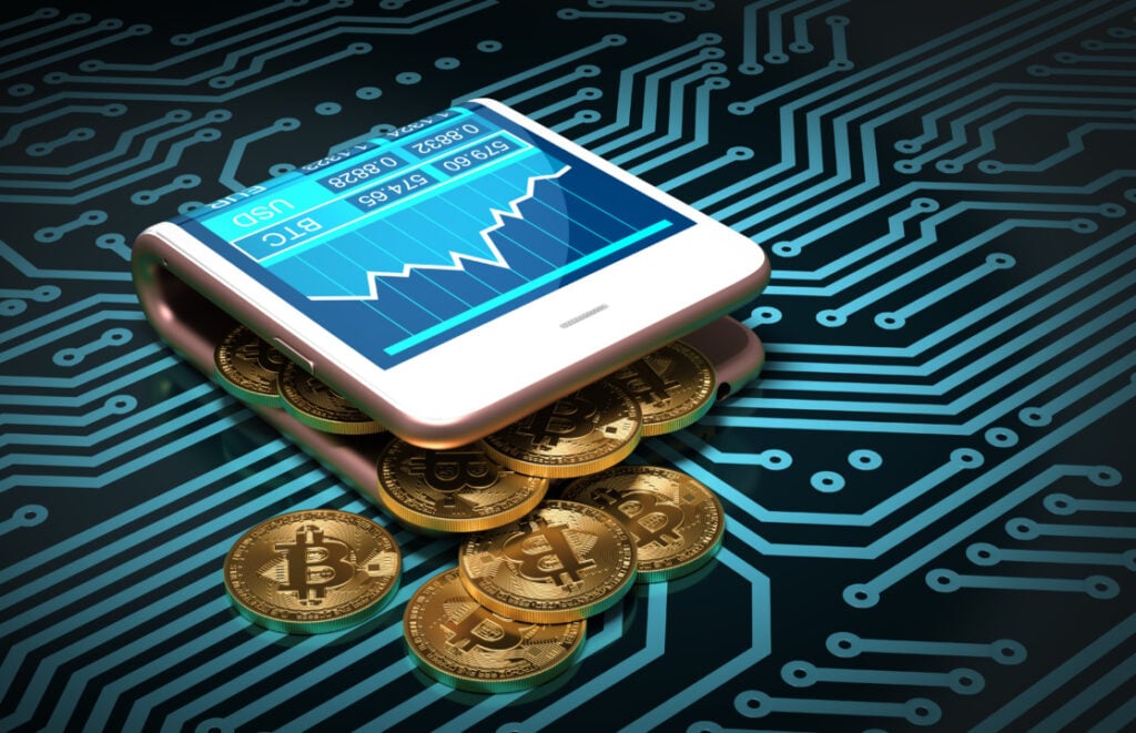 A digital wallet displaying a graph rests on stacks of Bitcoin coins over a circuit board pattern.