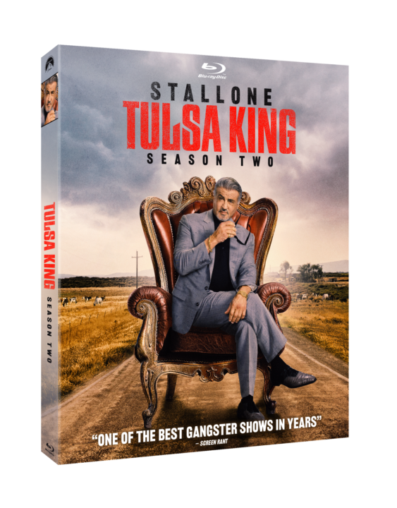 Blu-ray cover of "Tulsa King" Season Two featuring a man sitting in a chair on a road, with the sky and fields in the background.