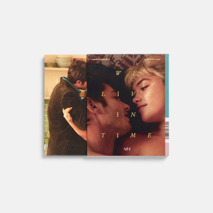 Two books slightly overlapping. The left shows a couple in an embrace, the right features a couple lying down with the title "We Live in Time.