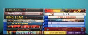 No Streaming Required: Physical Media Spotlight For The Week Of January 28th A collection of DVD and Blu-ray cases stacked in two columns against a blue background, featuring various film titles.
