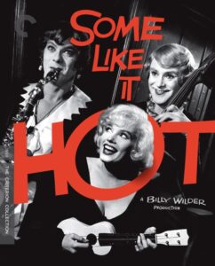 Black and white poster for "Some Like It Hot" featuring three characters, two in dresses playing instruments, and one in the center with a ukulele. Red text overlays the image.
