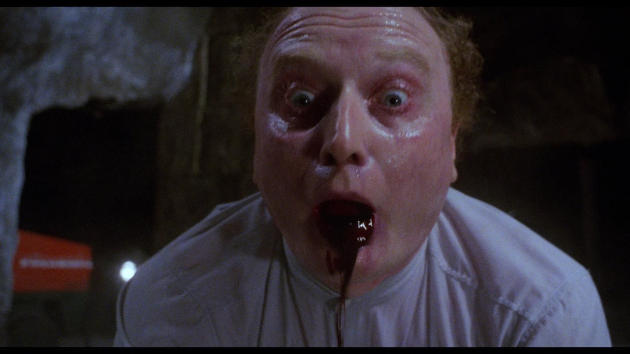 A startled person with wide eyes and mouth open, with dark liquid coming out.
