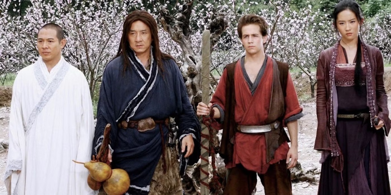 Four people in traditional Asian attire stand in front of blooming trees. The second person holds gourds, and the third holds a staff.