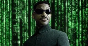 A person wearing sunglasses and a dark jacket stands confidently against a backdrop of green digital code.