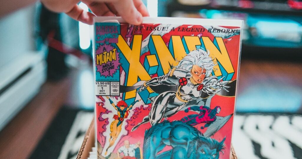 A hand holding a vintage X-Men comic book featuring Storm on the cover.