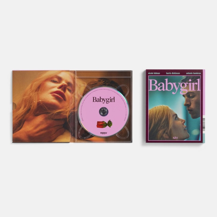Open DVD case of "Babygirl" with a pink disc featuring fruit graphics, alongside its cover showing a couple's close-up.