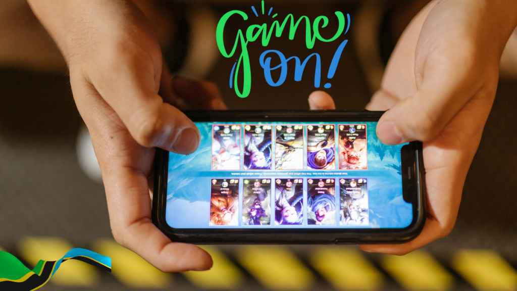 Person holding a smartphone displaying a video game interface. The words "Game On!" are written above the screen.