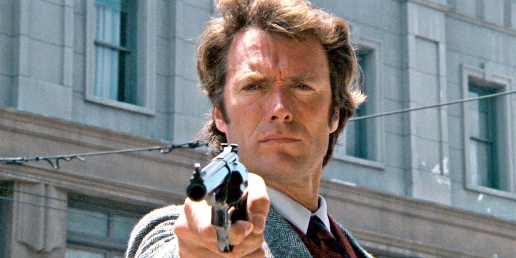 Person aiming a revolver in an urban setting.