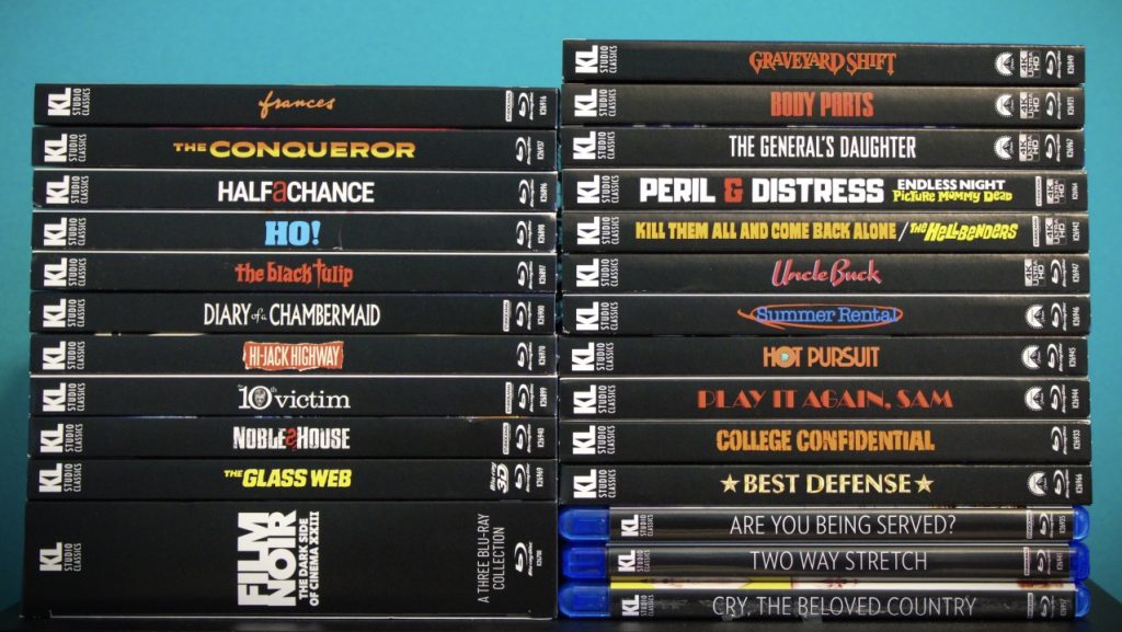 A stack of DVD and Blu-ray cases with various movie and TV show titles on the spines, arranged against a blue background.