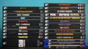 A stack of DVD and Blu-ray cases with various movie and TV show titles on the spines, arranged against a blue background.