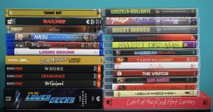 A collection of DVD and Blu-ray cases stacked in two columns against a blue background, featuring various movie titles.