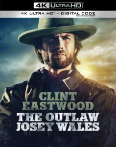 Cover of "The Outlaw Josey Wales" 4K Ultra HD, featuring a man in a cowboy hat and coat with a stern expression, standing against a cloudy sky backdrop.