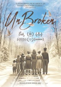 Poster for "UnBroken" with people standing on snowy train tracks, looking at a winter landscape. Includes film festival accolades and quotes praising the film.