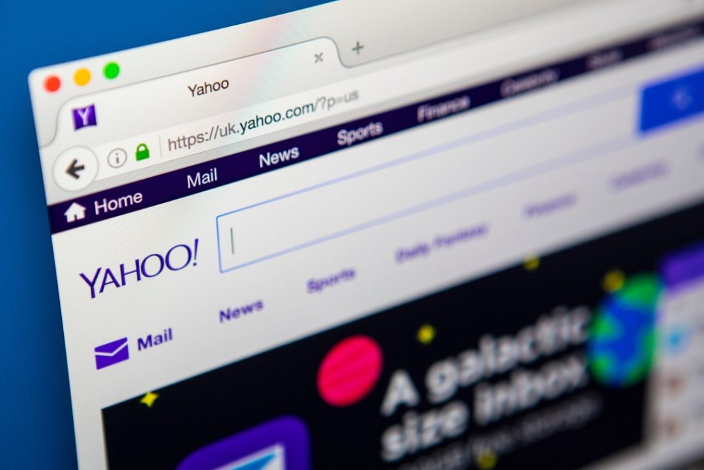 Close-up of a computer screen displaying the Yahoo UK homepage, with tabs for Mail, News, Sports, and Finance visible at the top.