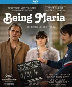Three people stand outdoors, two men and a woman, with a film clapperboard labeled "Dernier Tango à Paris" in front; Blu-ray cover for the film "Being Maria.