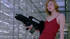 A person in a red dress holds a large gun in a futuristic hallway with glass walls.