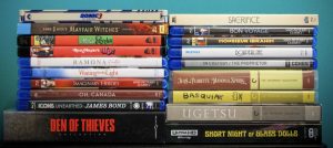 No Streaming Required: Physical Media Spotlight For The Week Of April 8th A collection of DVDs and Blu-rays stacked together, featuring various movie and TV show titles on their spines.