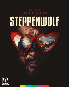 Movie poster for "Steppenwolf" featuring a man's face wearing heart-shaped sunglasses, reflecting a woman holding a book; text includes film title and director's name.