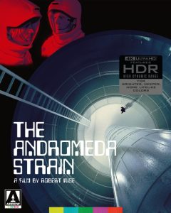 Two people in red hazmat suits look at each other above a futuristic tunnel; text reads "The Andromeda Strain, a film by Robert Wise.
