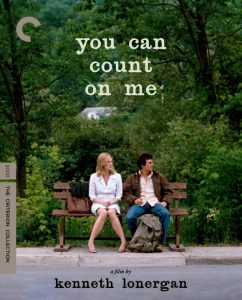 Two people sit on a bench in front of lush greenery. Text above reads "you can count on me." Below, it says "a film by kenneth lonergan" and "The Criterion Collection.