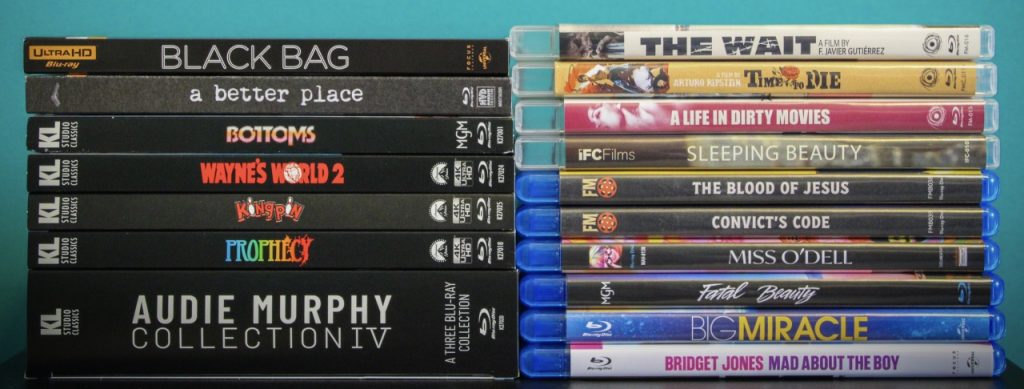 A selection of DVD and Blu-ray movie cases arranged in two vertical stacks against a teal background.