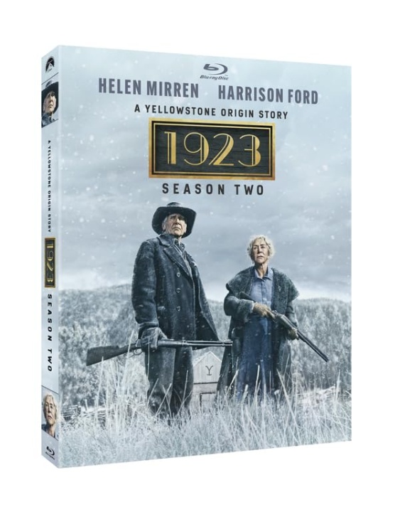 Blu-ray box cover for "1923 Season Two" featuring two characters standing outdoors in winter, both holding guns, with snow falling around them.