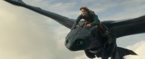 A young person in green clothes rides on the back of a large, black dragon with green eyes, flying through the cloudy sky.