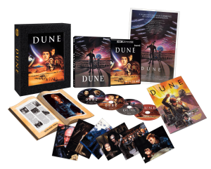 Collector’s edition box set of the movie "Dune," featuring a case, multiple discs, a booklet, art cards, and a poster, all laid out against a black background.