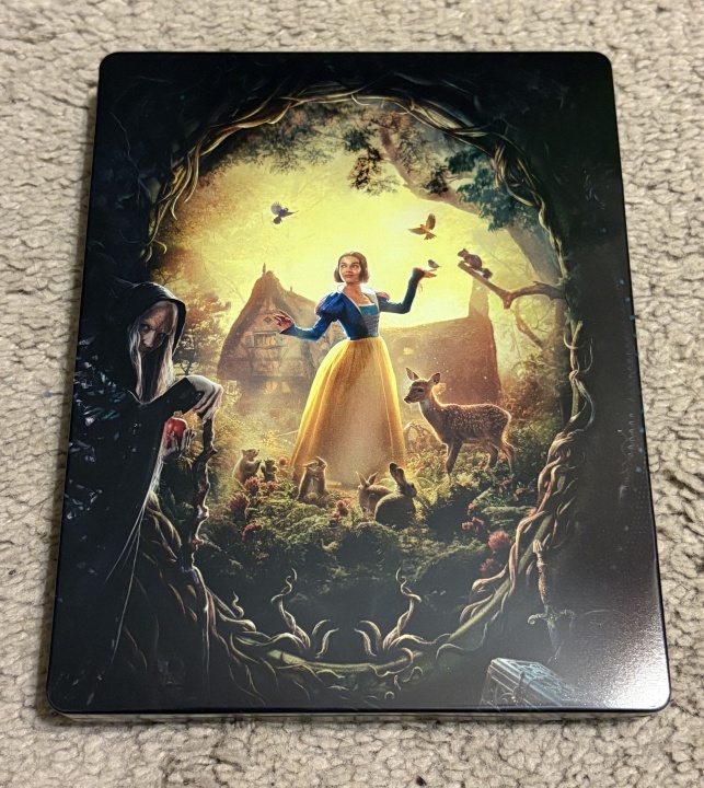 A card depicts a woman in a yellow skirt surrounded by woodland animals, with an old hooded figure holding an apple in the shadows, and a cottage in the background.